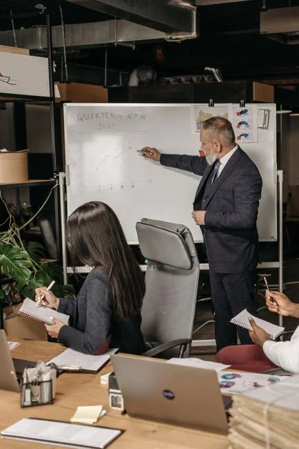 Group of business professionals collaborating in an office setting.